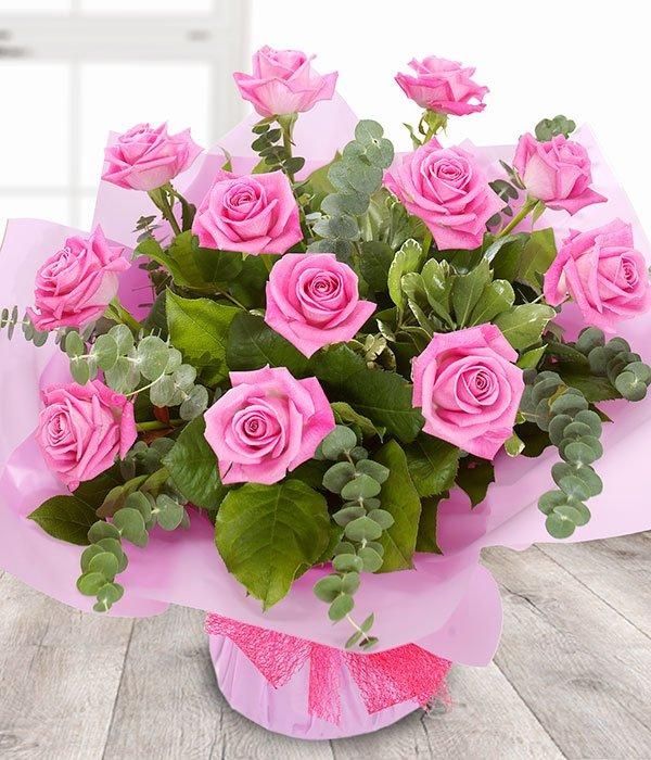 A Dozen Pink Roses in a vase